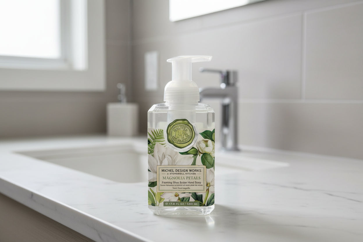 Clear bottle of Michel Design Works hand soap with floral design on a white background