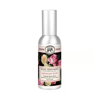 A silver metal container of Michel Design Works Midnight Rose Scented Room Spray with a floral label on the front.
