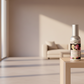 Room spray bottle with floral design and brand label on a white background