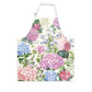 A cotton apron with a floral pattern featuring hydrangeas in pink, blue, and white colors, with green leaves and text on the pocket.