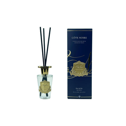 Côte Noire diffuser with clear bottle and gold accents on a white background