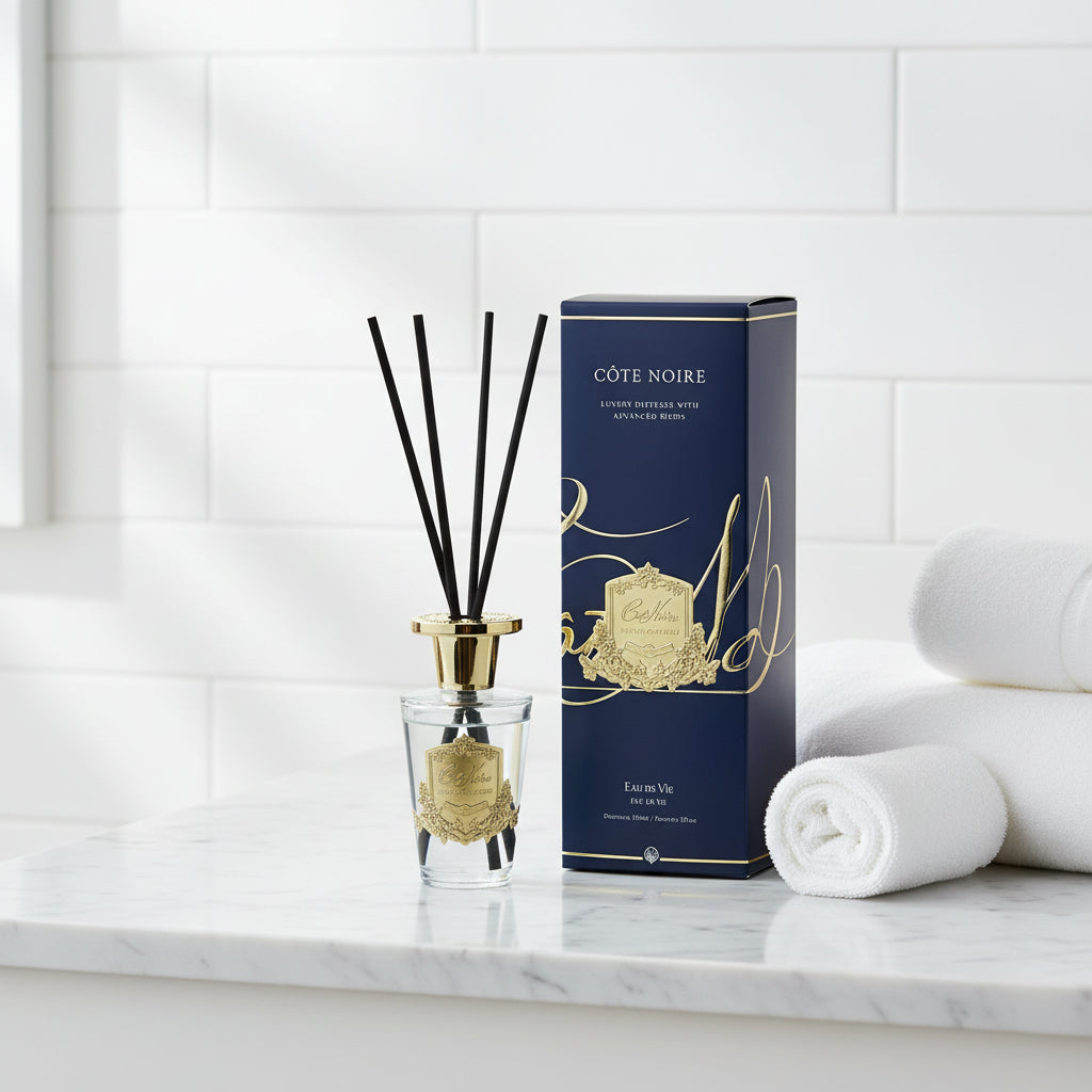 Côte Noire diffuser with clear bottle and gold accents on a white background