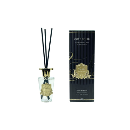 Côte Noire diffuser with black reeds and gold accents on a white background