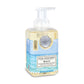 A pump bottle of Michel Design Works Beach Foaming Hand Soap with a label depicting a serene beach scene.